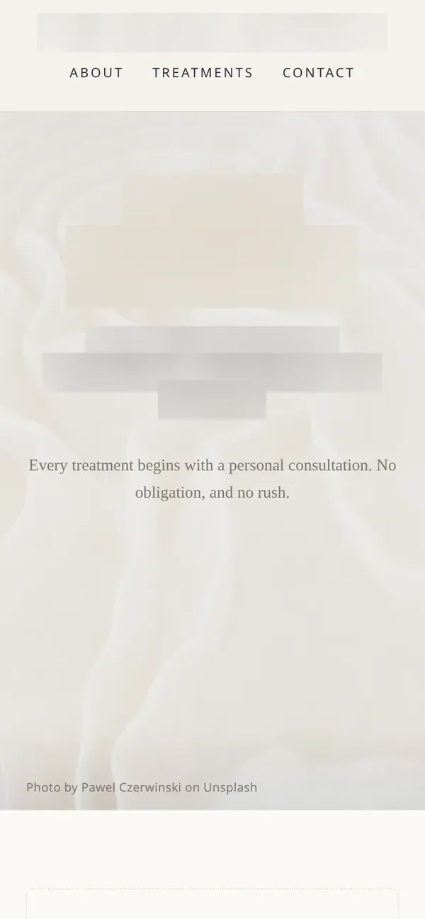 The clinic homepage design on a phone, with the clinic name and headline blurred
