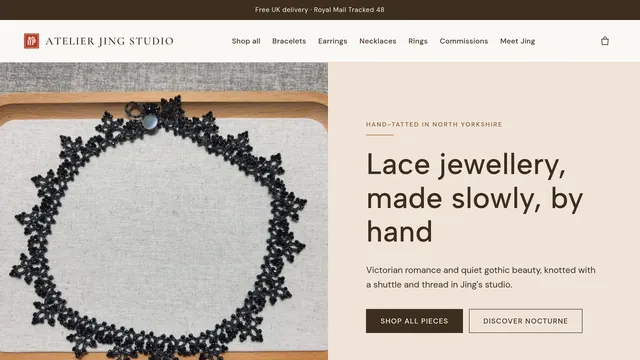 The Atelier Jing Studio homepage: a black tatted lace collar on a wooden tray beside the headline "Lace jewellery, made slowly, by hand"