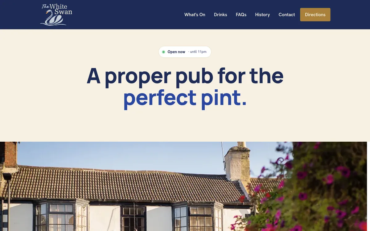 The White Swan website on a laptop: the headline "A proper pub for the perfect pint." above a photo of the pub
